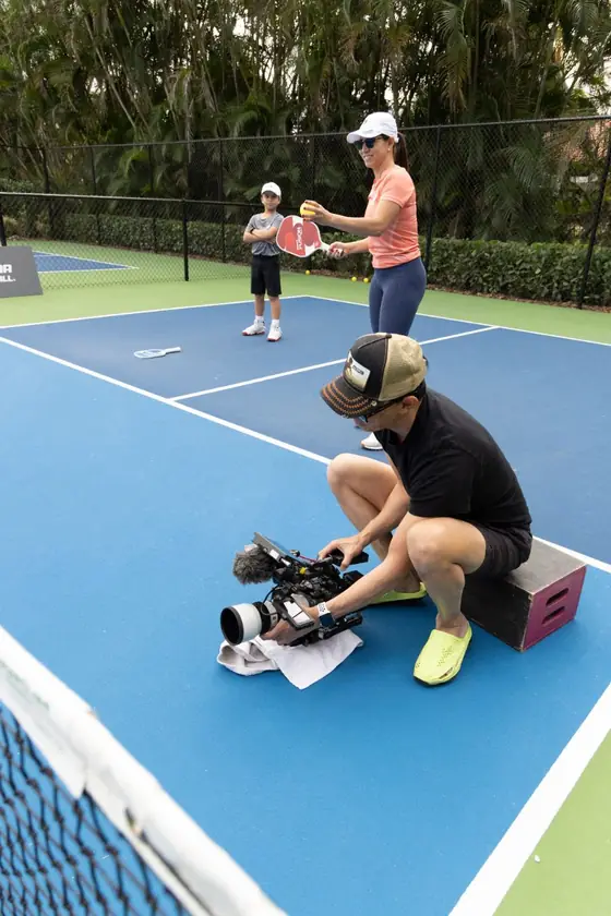 Filming a pickleball coaching session on court